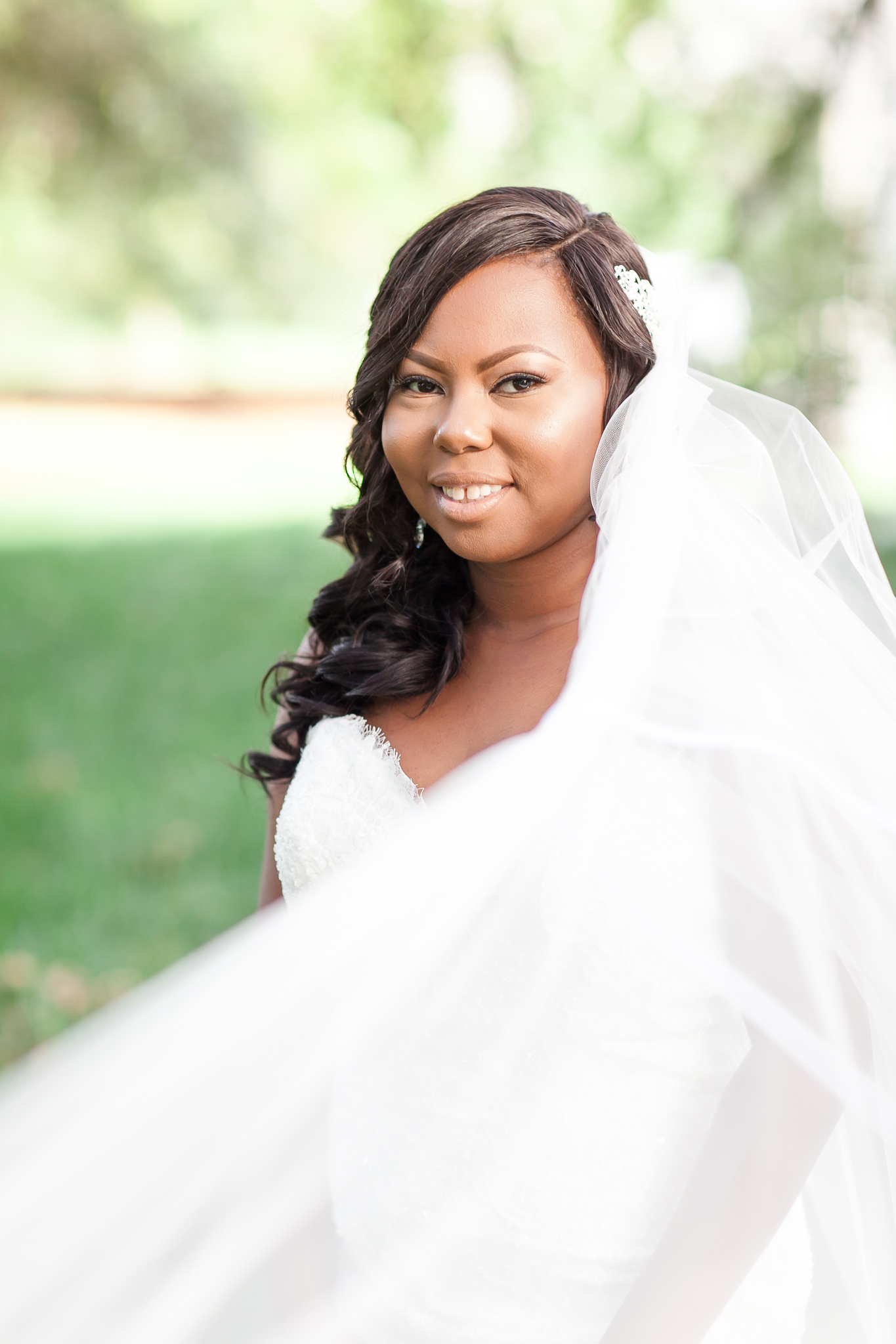 bride in wedding dress showing off veil in portrait session in Columbia, SC