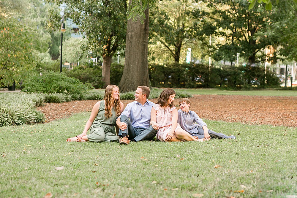 family sitting in grass,  using 5 posing hacks