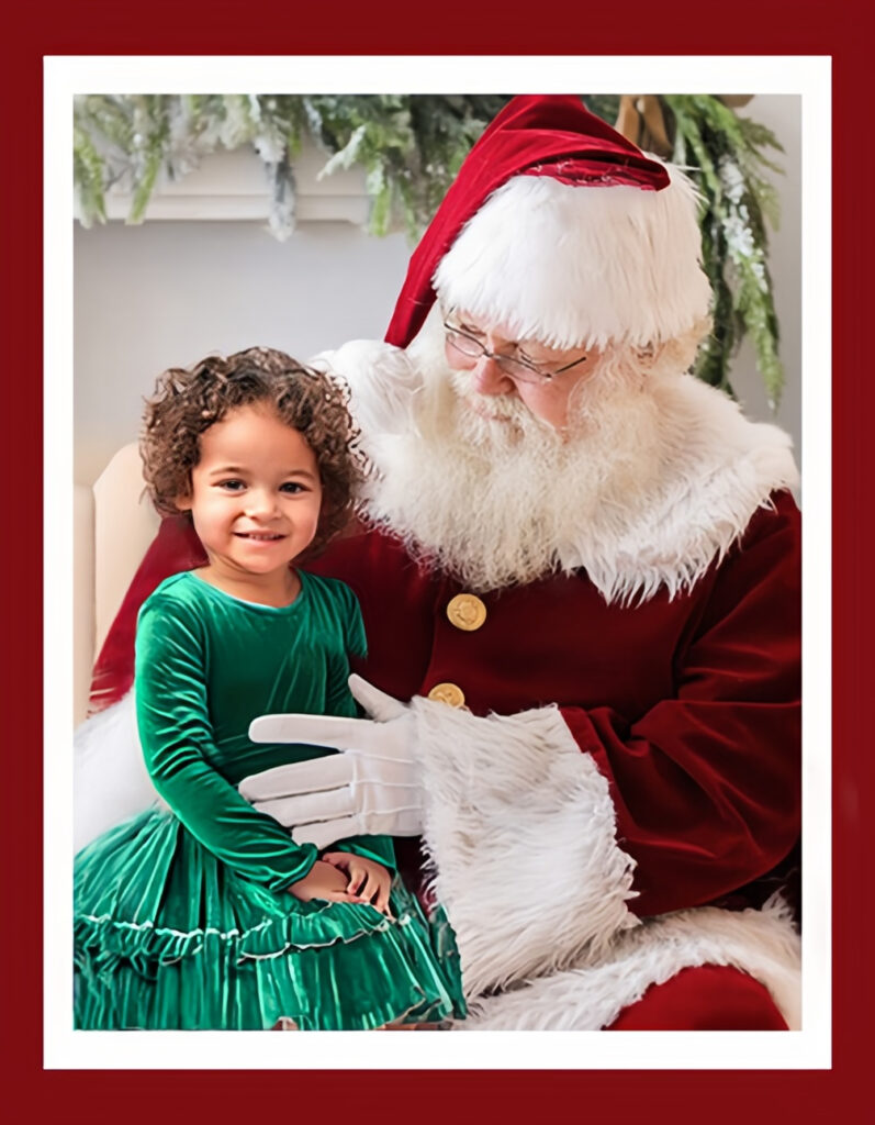 Little Girl sitting on Santa's lap for Santa pictures in Columbia SC