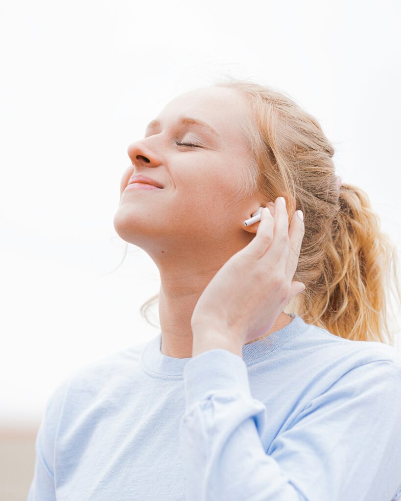 a new mom listening to airpods as part of self-care