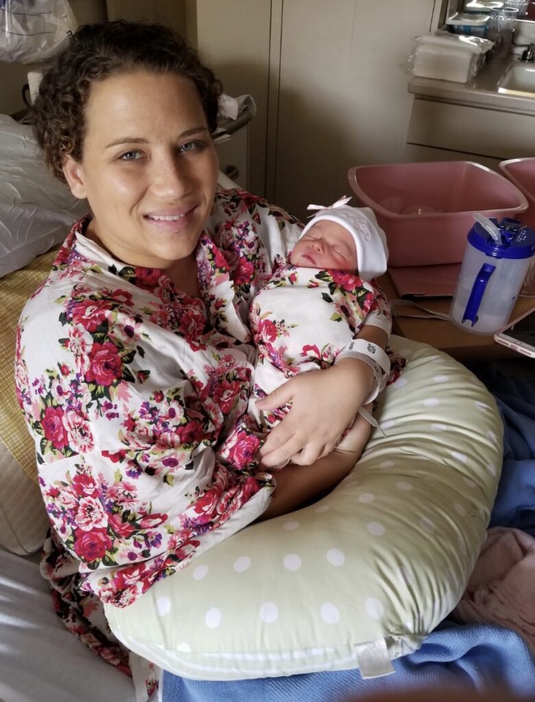 Emily Ann holding her baby girl in Columbia SC hospital wearing matching floral robes