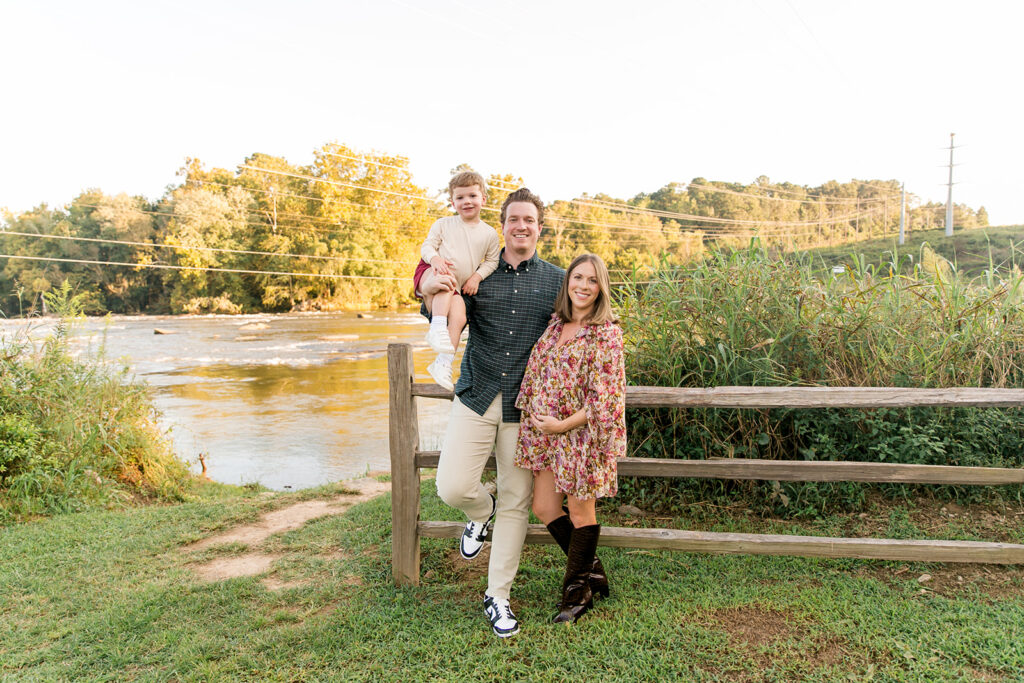 Outdoor maternity family photo session in Columbia SC by the river with parents and young child.